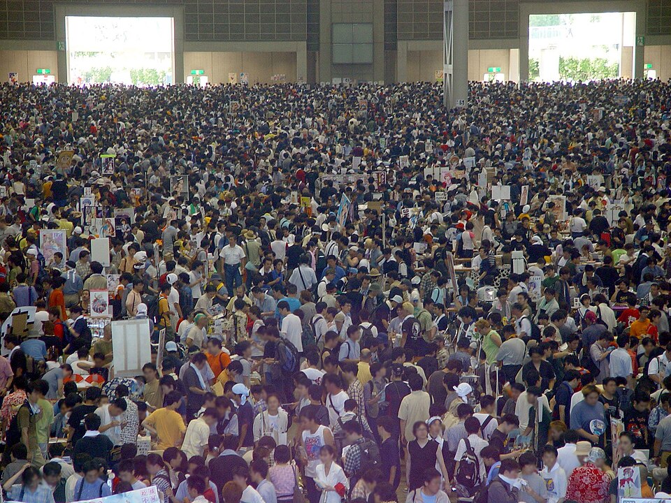 A sea of people gather at a convention center.